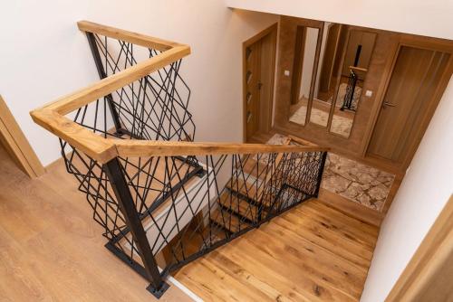 a room with a wooden staircase with a mirror at Villa Selzo lux in Pale