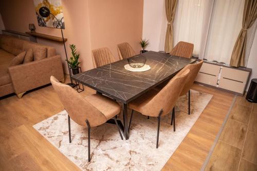 a dining room with a black table and chairs at Villa Selzo lux in Pale