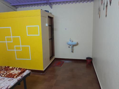 a bathroom with a yellow cabinet and a sink at Soham resort 