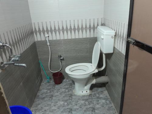 a bathroom with a toilet in a stall at Soham resort 