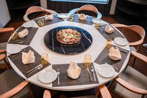 a table with a plate of pizza on it at Distrikt 9 in Palakkad