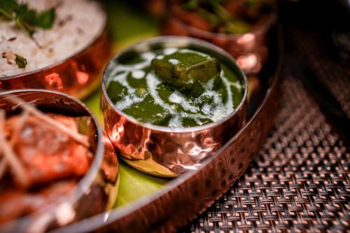 a table topped with bowls of food on a table at Distrikt 9 in Palakkad