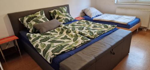 a bed in a room with a bedskirts at Ferienwohnung zwischen Rhein und Schwarzwald in Bischweier