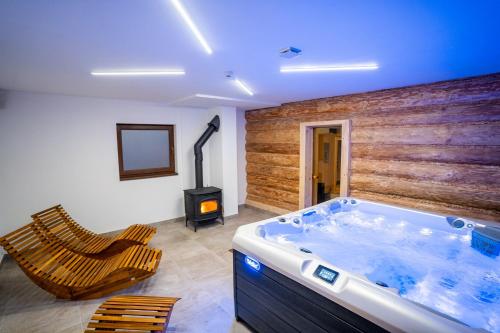 a large bathroom with a hot tub and a stove at Rezort pri Jazere Podbanské in Vysoke Tatry - Podbanske