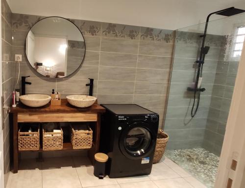 ein Bad mit einer Waschmaschine und einer Dusche in der Unterkunft VILLA CAJOU DESIRADE in Baie Mahault
