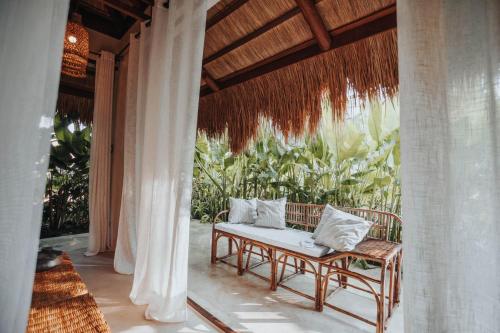 a porch with a bench on a patio at ALON Villas in El Nido