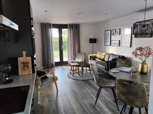 a living room with a couch and a table at Vakantiewoningen Eyveld in Beesel