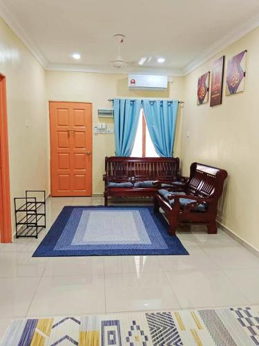 a living room with a couch and a window at Hanani Homestay in Shah Alam