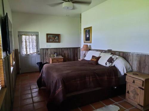 a bedroom with a large bed and a table at Waterfront Ranch Home + Bunk Barn + Guest Cabin in Alba