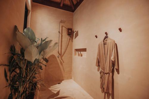 a mannequin in a room with a shower at ALON Villas in El Nido