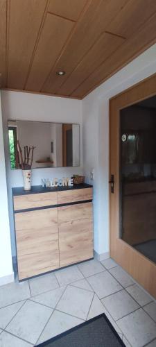 a kitchen with a wooden cabinet and a door at Ferienhaus Günther in Aue