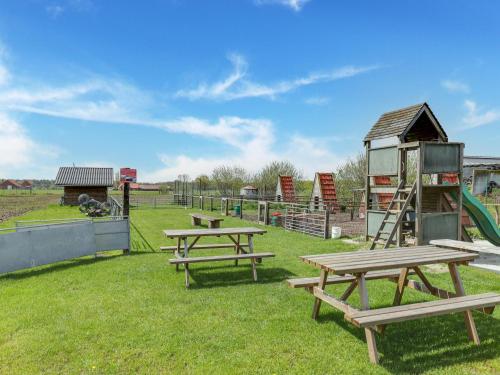 a park with picnic tables and a playground at In de Wollekjes in Merksplas