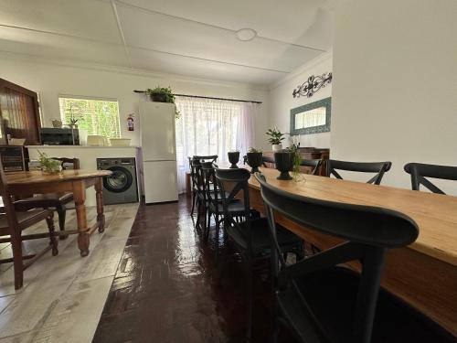 a kitchen and dining room with a long table and chairs at INBLOEM in Bloemfontein