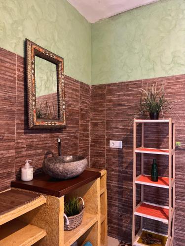 a bathroom with a sink and a mirror at La Pita Guesthouse in Almería