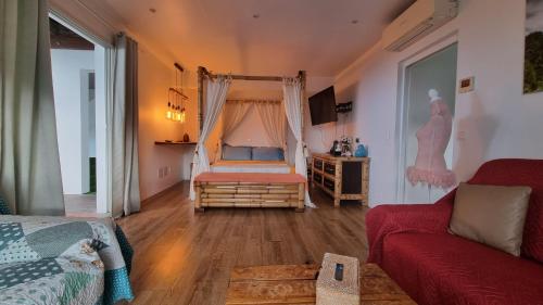 a living room with a bed and a couch at Villa Des Remparts in Sainte-Marie