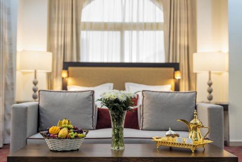 a hotel room with a bed and a table with fruit on it at Al Joud Hotel Makkah in Makkah