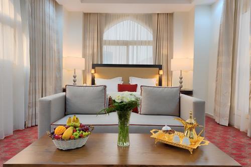 a hotel room with a bed and a table with fruit on it at Al Joud Hotel Makkah in Makkah