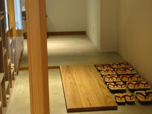 a room with a bunch of shoes on the floor at Kinsui Annex in Toyooka
