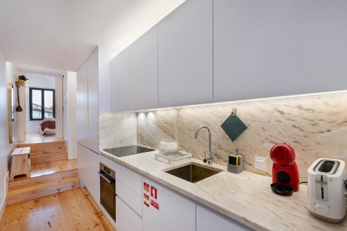 a kitchen with a sink and a counter top at Fontainhas Royal in Porto