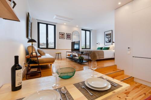 a living room with a table and a couch at Fontainhas Royal in Porto