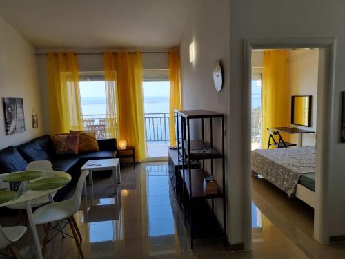 a living room with a couch and a bed and a table at Apartman Rene, 150m from the sea, panorama view, Crikvenica, Dramalj, parking in Dramalj