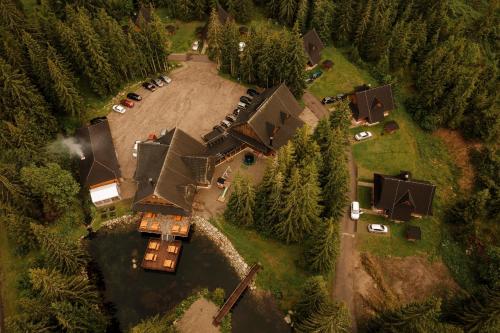 an aerial view of a house in the woods at Rezort pri jazere Podbanské in Pribylina