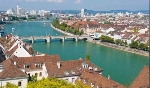 a view of a river in a city with a bridge at Schweiz (301) in Basel