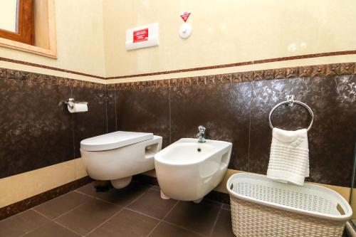 a bathroom with a toilet and a sink at Brilant Antik Center in Tirana