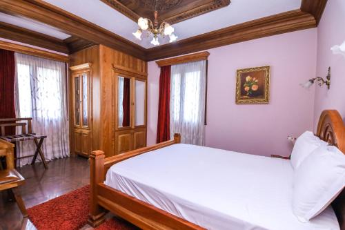 a bedroom with a bed and a chandelier at Brilant Antik Center in Tirana