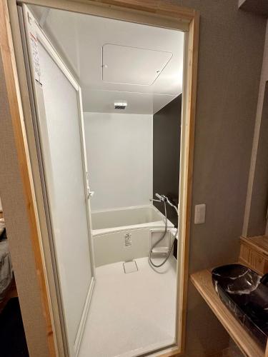 a shower with a glass door in a bathroom at Fuji Dome Glamping in Fujikawaguchiko