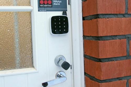 a door with a remote control on it at Kuukkeli Apartments Inari in Inari