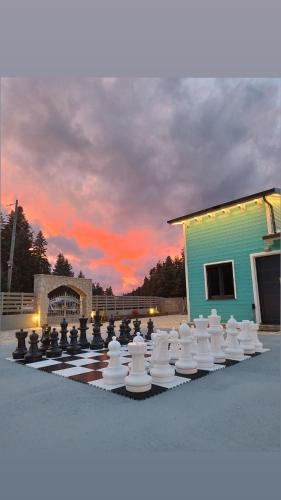 a large chess board with a sunset in the background at Casa de Madera in Pávliani