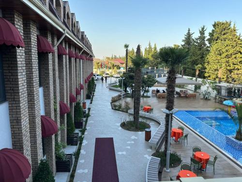 a view of a resort with a pool and tables and chairs at Mandarinnart HOTEL in Astara