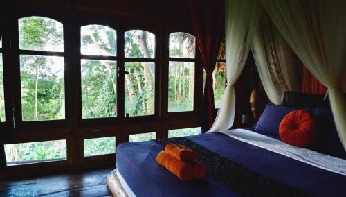 a bedroom with a bed with a stuffed animal on it at Lua Pu Luong in Pu Luong