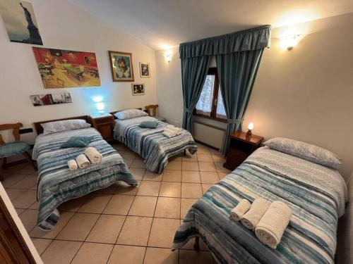 a bedroom with two beds and a window at Vacanze Versilia in Viareggio