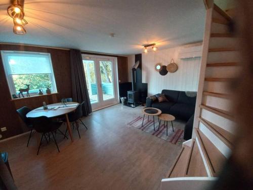 a living room with a staircase leading to a living room at Fritidshus Hammare Hagfors in Hagfors