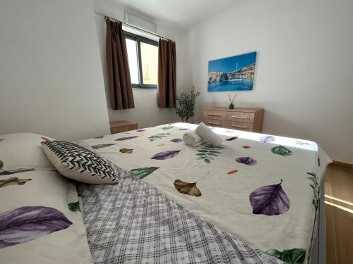 a bedroom with a bed with a comforter on it at Luxurious Sliema Ferry central location in Sliema