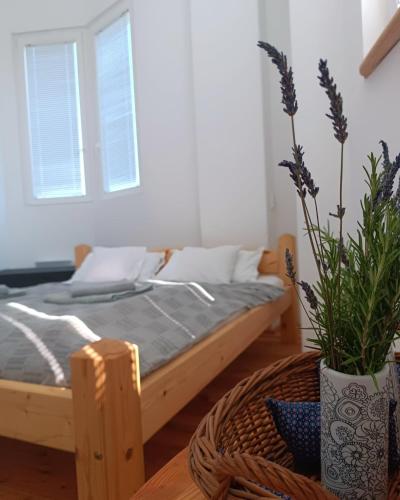 a bedroom with a bed and a table with a basket at ToronySzoba in Szob