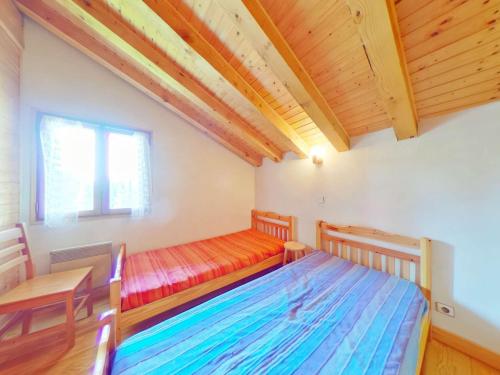 a bedroom with a bed and a desk and a window at Chalet Les Saisies, 4 pièces, 8 personnes - FR-1-594-42 in Hauteluce