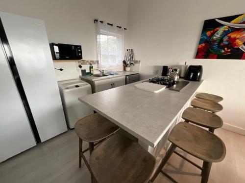 a kitchen with a counter and a kitchen with a refrigerator at Bloudam Wilderness in Wilderness