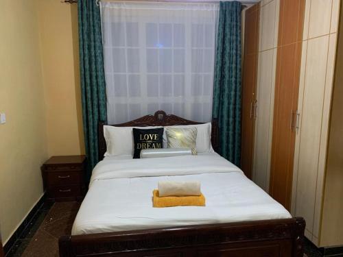 a bedroom with a large bed with a window at Peaceful Haven in Eldoret