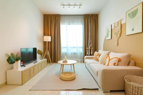 a living room with a couch and a tv at Greenfield Residence At Sunway City by Nexx Field in Petaling Jaya