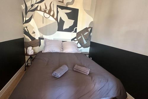 a bed in a room with two pillows on it at Destination Léman in Thonon-les-Bains