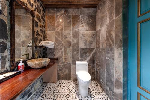a bathroom with a toilet and a sink at ChezCao Rice Field Ecolodge Ninh Binh in Ninh Binh