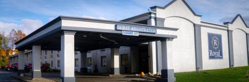 a white building with a sign on the front of it at Royal Inn & Suites in Akron