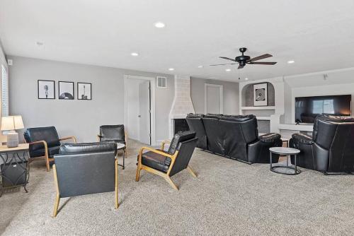 a living room with leather chairs and a flat screen tv at Modern Home-Garage-Scenic Patio in Rapid City