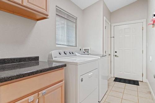 uma cozinha branca com um lavatório e uma janela em Modern Home-Garage-Scenic Patio em Rapid City
