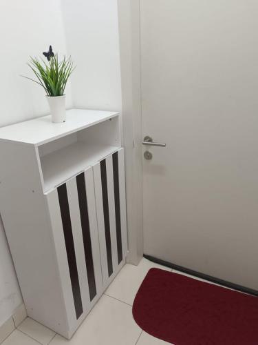 a bathroom with a white sink and a red rug at KLIA Travel Homestay - 3R 2B - WIFI & NETFLIX in Sepang
