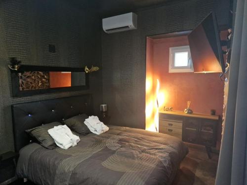 a bedroom with a bed with two towels on it at Le nid douillet in Chaumuzy