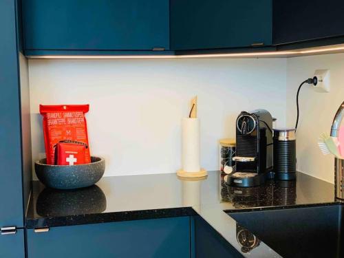 a kitchen with a counter top with a coffee maker at Lovely and exclusive northern lights apartment with excellent view. in Tromsø